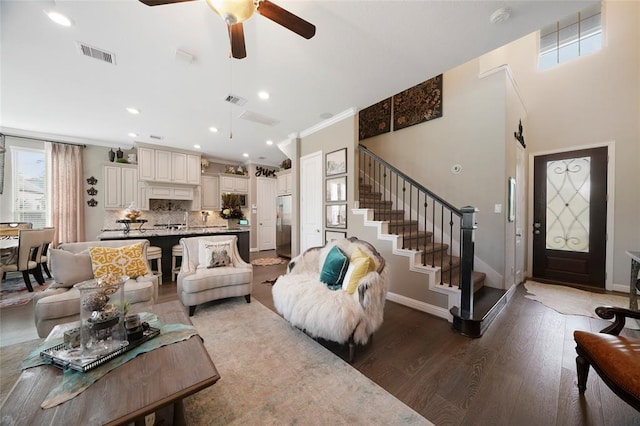 living room featuring crown molding, ceiling fan, and hardwood / wood-style floors