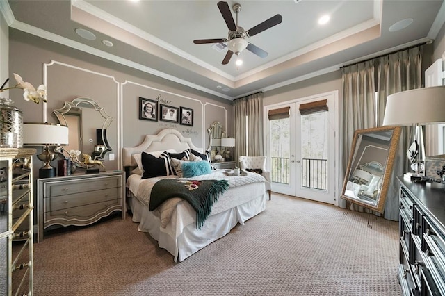 bedroom with ceiling fan, carpet flooring, french doors, access to outside, and a raised ceiling