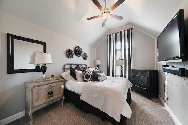 carpeted bedroom featuring ceiling fan and vaulted ceiling