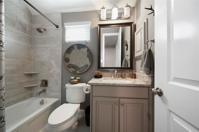 full bathroom featuring tiled shower / bath combo, vanity, and toilet