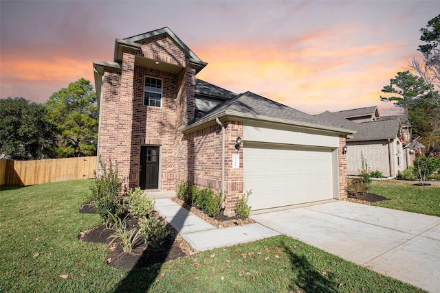 front of property with a garage and a yard