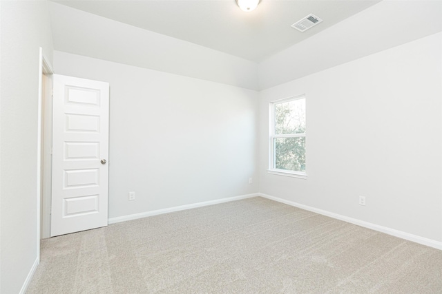 spare room featuring light colored carpet