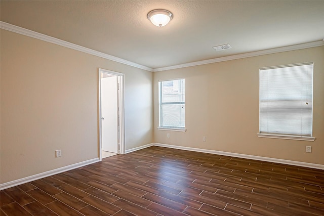 empty room with crown molding and a textured ceiling