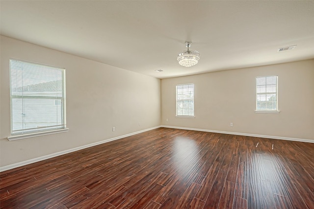 empty room with dark hardwood / wood-style flooring