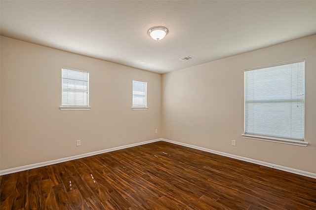 empty room featuring dark hardwood / wood-style floors