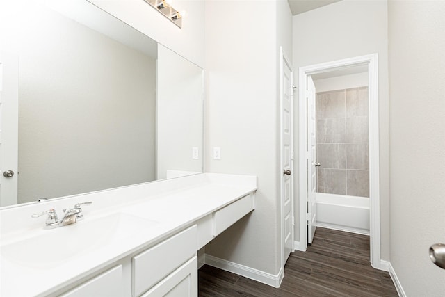 bathroom featuring vanity, wood-type flooring, and shower / washtub combination