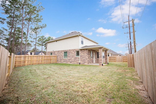 back of house with a yard