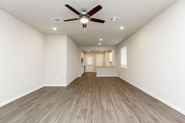 unfurnished living room with hardwood / wood-style flooring and ceiling fan