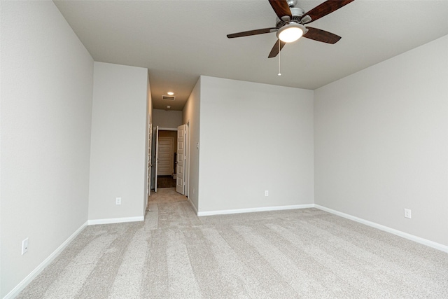 spare room featuring light carpet and ceiling fan