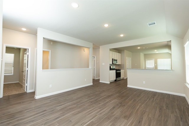 unfurnished living room featuring dark hardwood / wood-style flooring and lofted ceiling