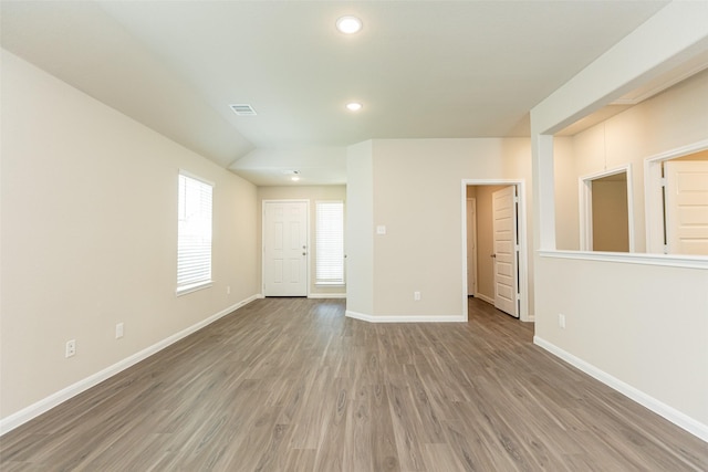 empty room with hardwood / wood-style flooring