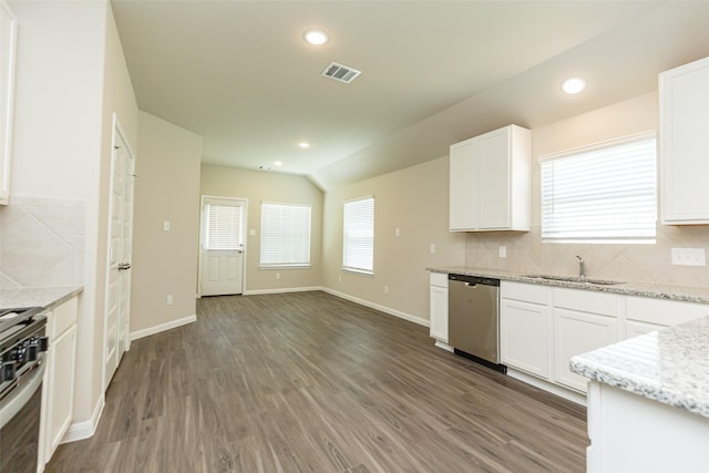 kitchen with white cabinetry, appliances with stainless steel finishes, sink, and light stone counters