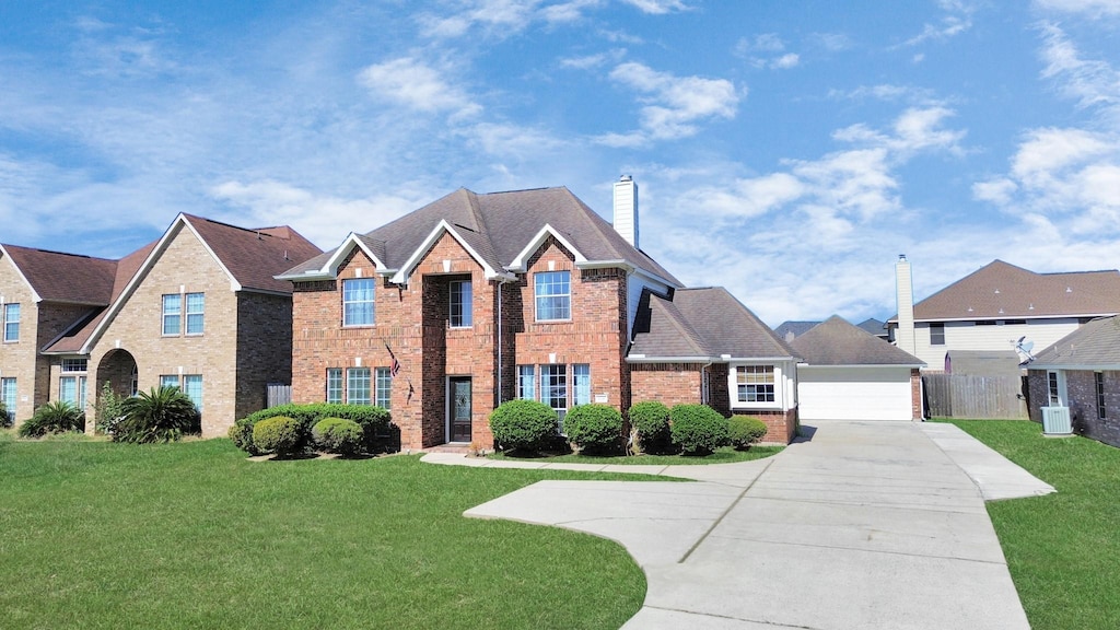 view of front of home with a garage and a front lawn