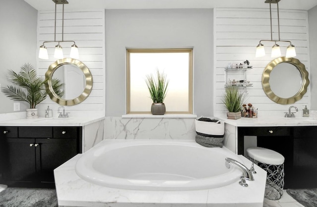 bathroom with a relaxing tiled tub and vanity