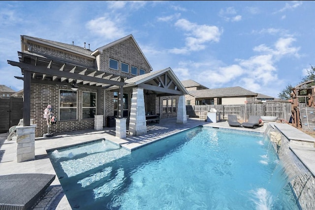 view of pool with pool water feature, a patio area, and a pergola