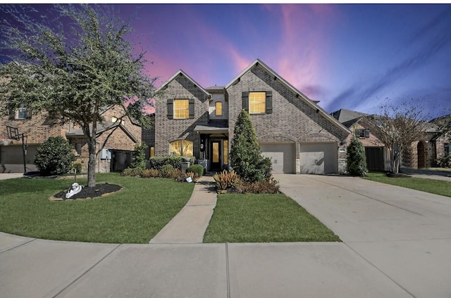 view of front of home featuring a garage and a yard