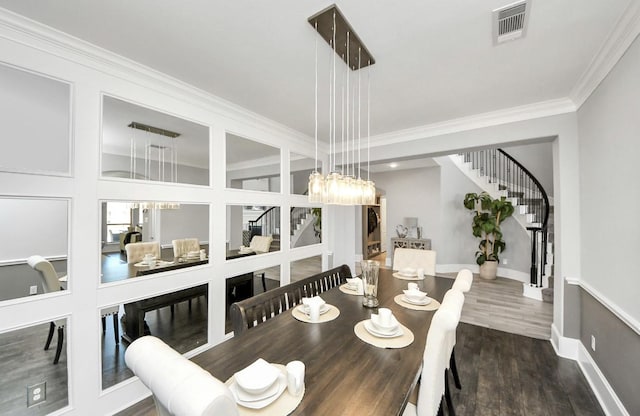 dining space with crown molding, dark hardwood / wood-style floors, and a chandelier