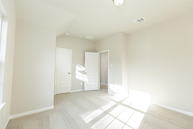 unfurnished bedroom featuring light carpet