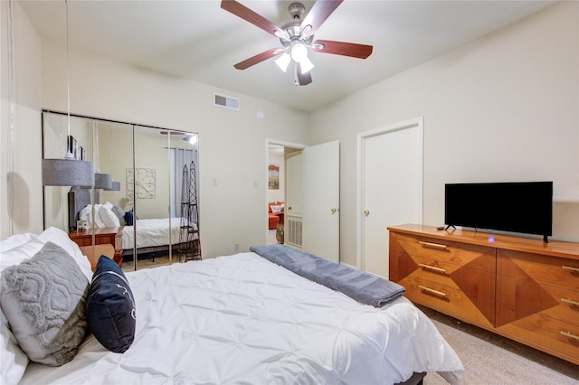 bedroom featuring carpet floors, ceiling fan, and a closet