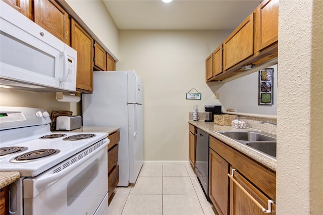 kitchen featuring sink, white appliances, and light tile patterned floors