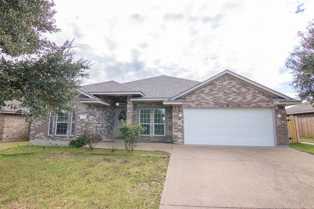 single story home featuring a garage and a front yard