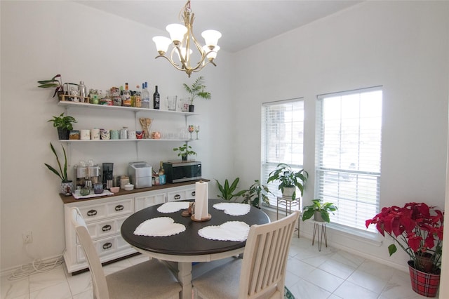 tiled dining area with a chandelier