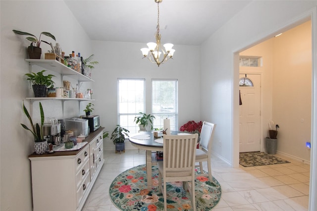 dining room with light tile patterned floors and a chandelier