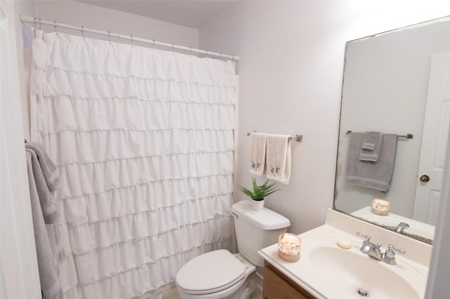 bathroom with vanity, curtained shower, and toilet