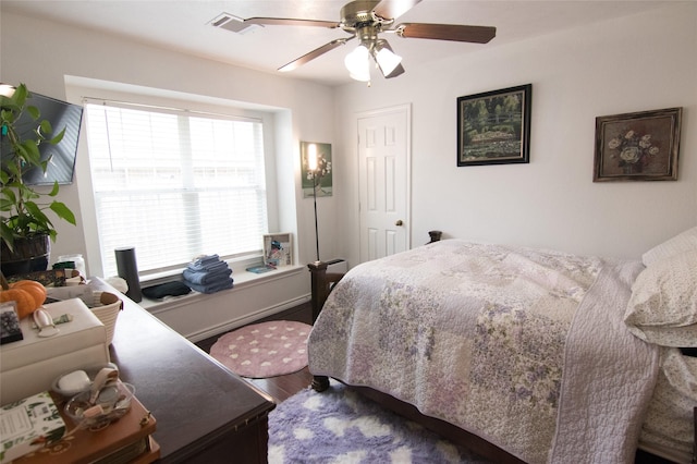 bedroom featuring hardwood / wood-style flooring and ceiling fan