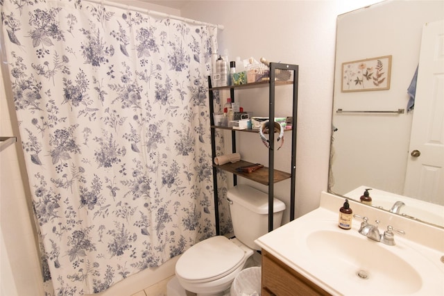 bathroom featuring vanity, toilet, and curtained shower