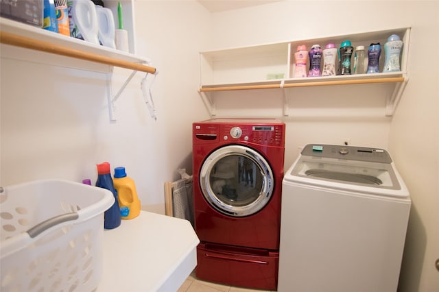 washroom featuring light tile patterned floors and washer and dryer