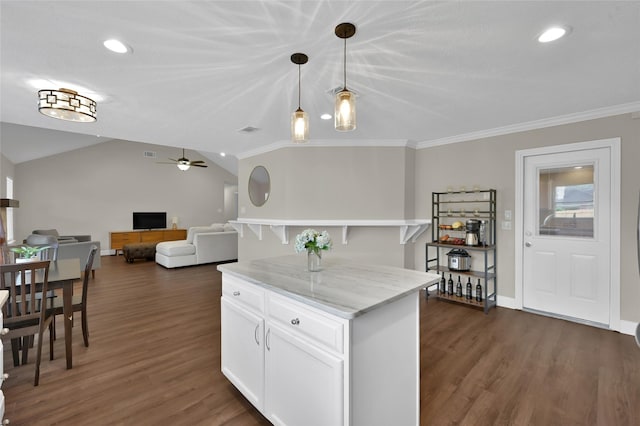 kitchen featuring lofted ceiling, hanging light fixtures, dark hardwood / wood-style flooring, light stone countertops, and white cabinets