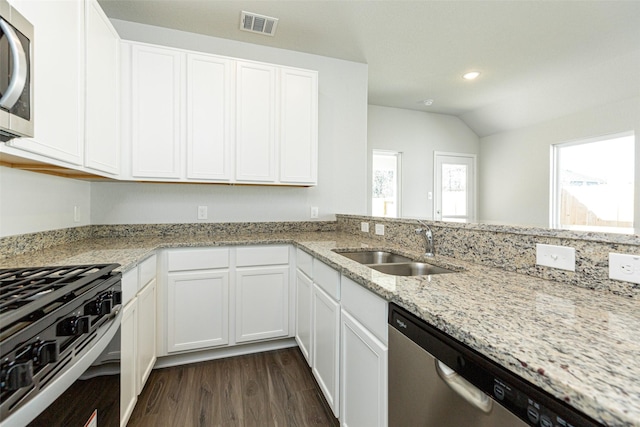 kitchen featuring dark hardwood / wood-style floors, sink, white cabinets, light stone counters, and stainless steel appliances