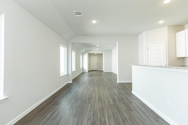 unfurnished living room with dark wood-type flooring