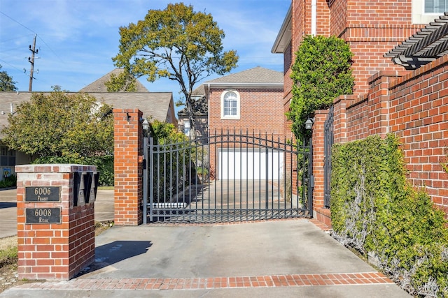 view of gate with a garage