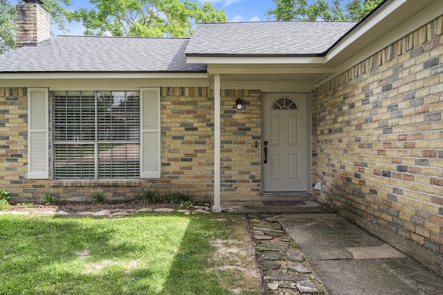 doorway to property featuring a lawn