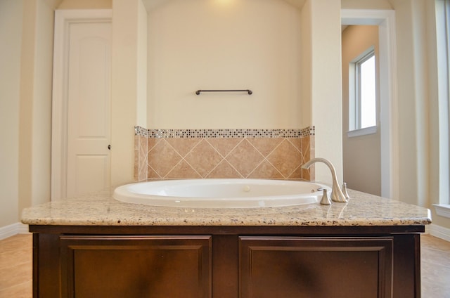 bathroom featuring a washtub and tile patterned floors