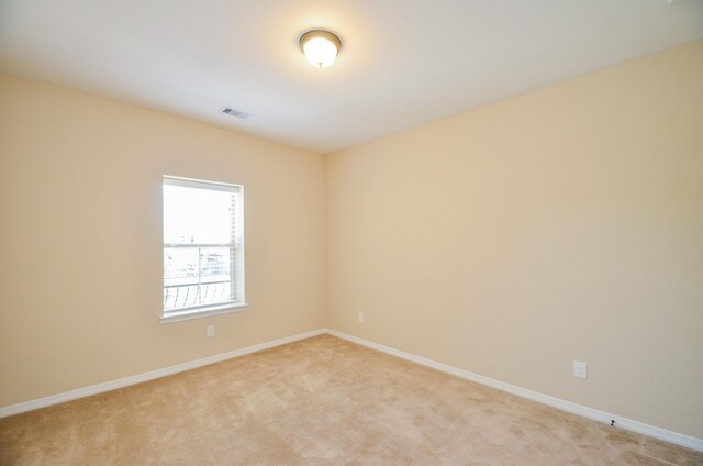 empty room with light colored carpet