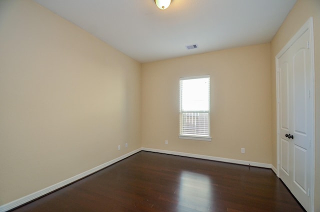 unfurnished bedroom with dark wood-type flooring