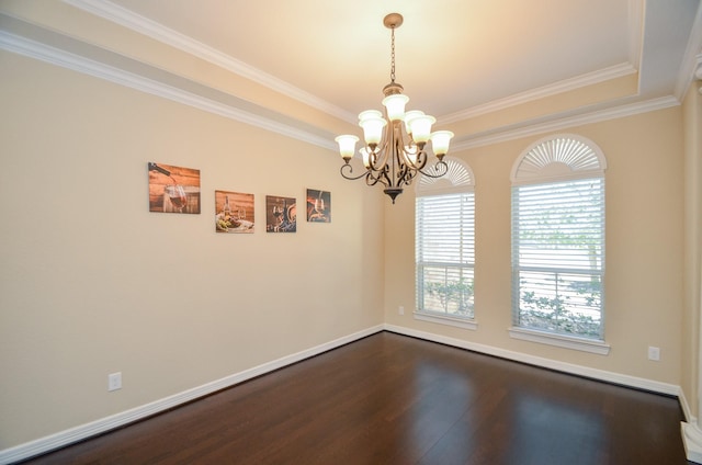 spare room with crown molding, dark hardwood / wood-style flooring, and a notable chandelier