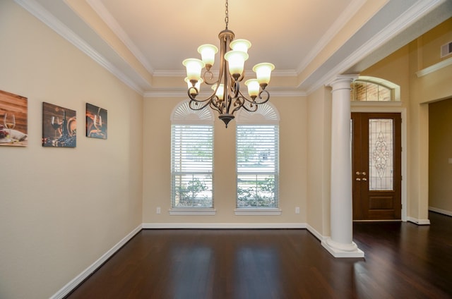 unfurnished dining area featuring dark wood-type flooring, ornamental molding, and ornate columns