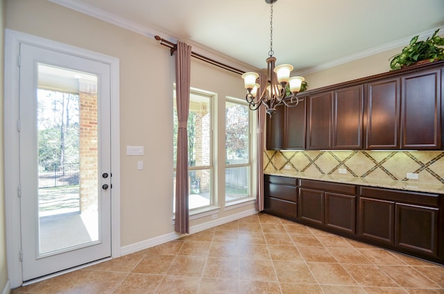 kitchen with crown molding, decorative backsplash, dark brown cabinets, and decorative light fixtures