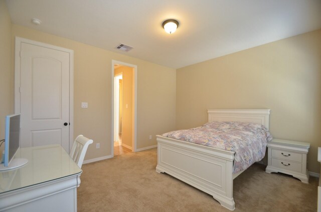 bedroom featuring light carpet