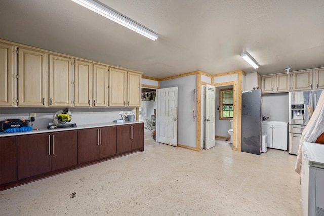 kitchen with stainless steel refrigerator with ice dispenser, dark brown cabinets, and cream cabinetry