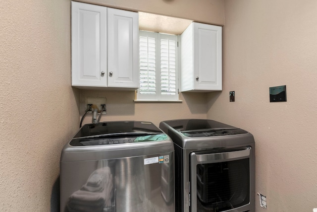 laundry room with cabinets and separate washer and dryer