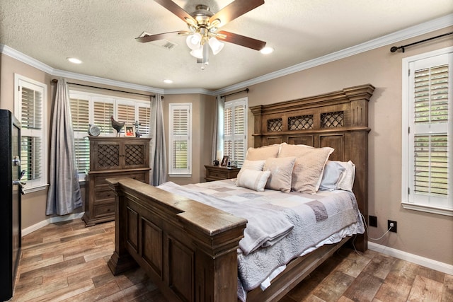 bedroom featuring crown molding, ceiling fan, and a textured ceiling