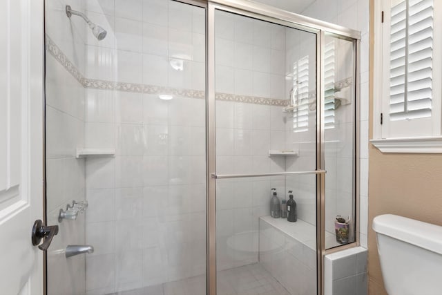 bathroom with toilet and walk in shower