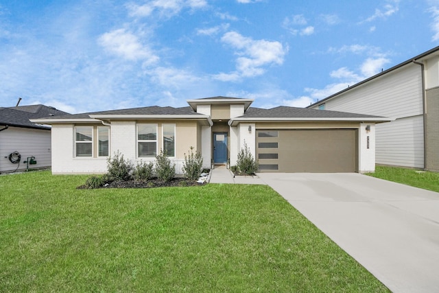 view of front of house with a garage and a front yard