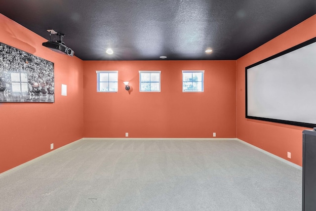 carpeted cinema with a textured ceiling