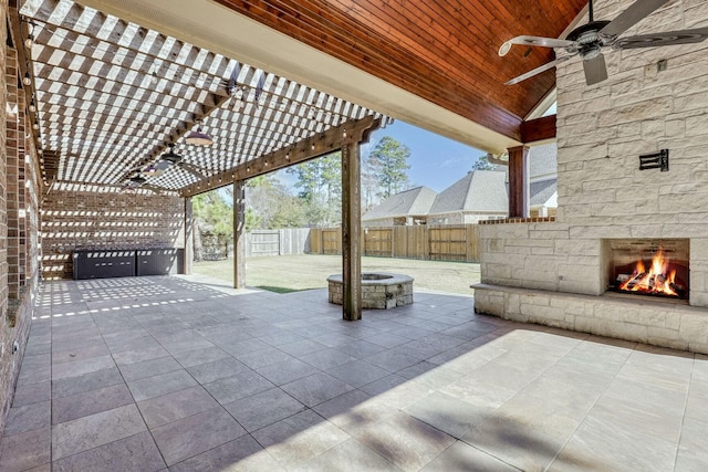 view of patio featuring an outdoor stone fireplace